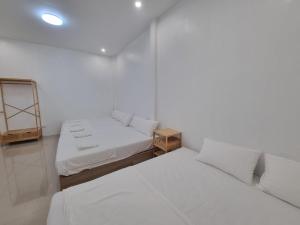 a white room with two beds and a mirror at Hadkaew Thepha Pool Villa by Jehsana in Ban Krong I Tam +64 photos