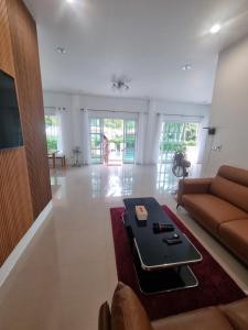 a living room with a couch and a table at Hadkaew Thepha Pool Villa by Jehsana in Ban Krong I Tam