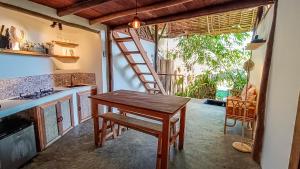 a kitchen with a wooden table and a ladder at Zen Treehouse in General Luna