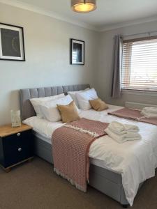 two beds sitting next to each other in a bedroom at Covesea Horizon in Elgin