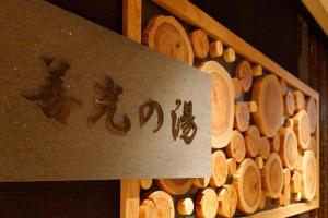 a sign with asian writing next to a pile of wood at Dormy Inn Nagano in Nagano