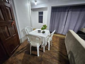a white table and chairs in a living room at Departamento esmeralda in Chota