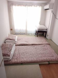 Postel nebo postele na pokoji v ubytování Wise Park Mukojima