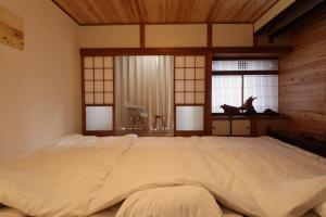 Postel nebo postele na pokoji v ubytování Value Residence Hotel 西之表