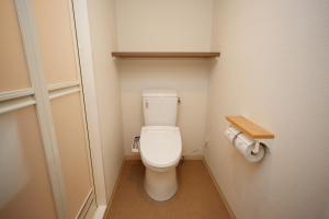 a small bathroom with a toilet in a room at Dormy Inn Nagano in Nagano