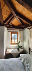 a bedroom with a bed and a window at koule Tasoula in Monemvasia