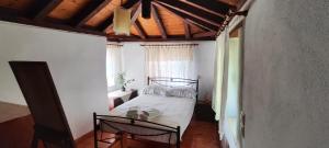 a bedroom with a bed and a window at koule Tasoula in Monemvasia