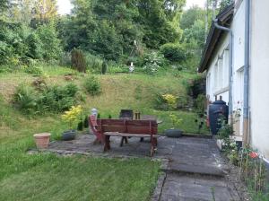 a bench sitting in a yard next to a house at Eifelerlebnis in Jünkerath