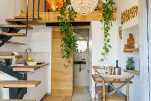 a kitchen with wooden stairs and a dining room at L'Oxalis villa (Le Cocon) in Bullion