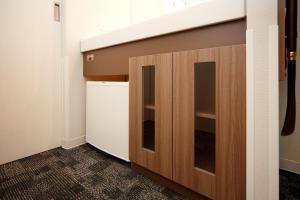 a laundry room with a washer and dryer at Dormy Inn Nagano in Nagano