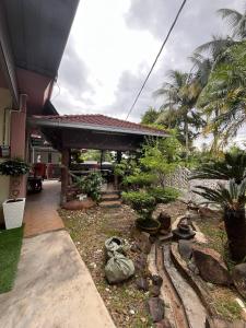 a house with a garden in front of it at Sha Homestay in Marang