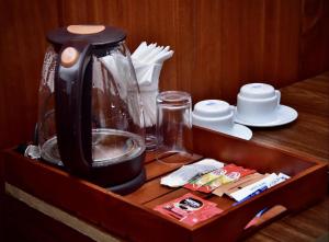 a wooden drawer with a coffee maker on it at Forest Edge Holiday Inn in Nuwara Eliya +10 photos