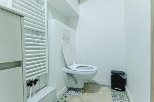 a white bathroom with a toilet and a window at Elegant 3BR & 1LR Waterfront Retreat in Ghent in Ghent +44 photos