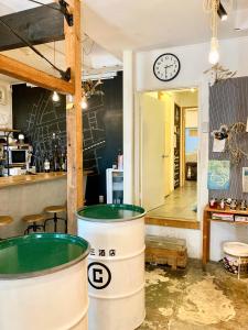 a room with a clock on the wall and two barrels at 2no HOME & PARK in Kobe +57 photos
