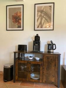 a wooden cabinet with a coffee maker on top of it at Ferienwohnung Hofliebe in Päpinghausen in Minden