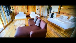 a room with two beds and a couch at Daelorpu 3 in Chom Thong