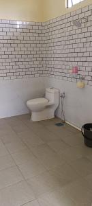 a bathroom with a toilet in the corner of a wall at MyMama Homestay in Pasir Mas +20 photos