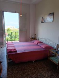 a bedroom with a large bed with a large window at Villa Mirabelli in Tropea