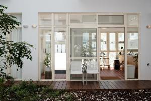 a glass house with a table and two white chairs at 洋Casa in Hengchun South Gate