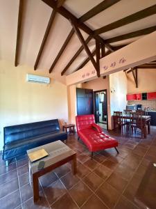 a living room with a blue couch and a red chair at INSPIRA THASSOS APARTMENTS and STUDIOS in Skala Sotiros