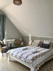 a bedroom with a bed with a floral bedspread at Hajnica GórSki in Wisła