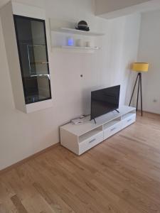 a living room with a flat screen tv on a white cabinet at Niko Fundali in Bitola