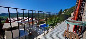 a balcony with a view of a pool and mountains at Villa Smoquizza in Smokvica