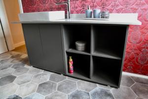 a bathroom vanity with a sink and a counter at Apartment Provence im Brikkhaus "regionale Historie trifft auf internationale Moderne" in Kläden +14 photos