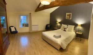 a bedroom with a white bed and a window at Le Logis in Angoulême +3 photos