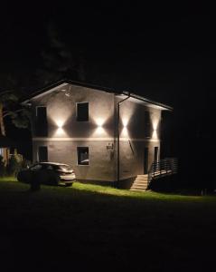 a house with a car parked in front of it at night at Dom całoroczny nad jeziorem do 10 osób Porost około 60km od morza in Porost