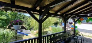 a screened porch with a view of a yard at Vikendica Iris in Laktaši