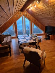 a living room with a table with a cow pattern on it at Roligheten hytte in Farsund