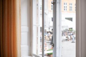an open window with a view of a city street at The Dukes apartment by Daniel&Jacob's in Copenhagen +25 photos