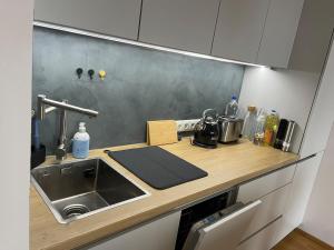 a kitchen with a sink and a counter top at Kristalli Studio with amenities, free parking in Tartu