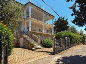 a white house with stairs and a fence at Blue Seagull in Utjeha