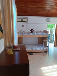a room with a bunk bed and a table at Selma Guest House Vlore in Vlorë