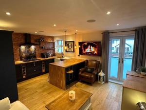 a kitchen with a desk and a chair in a room at Executive 1bd 1st floor flat in Caerleon