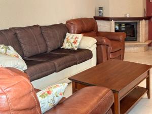 a living room with a couch and a table at Blue Seagull in Utjeha