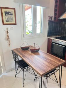 a kitchen with a wooden table with two baskets on it at VERADA HOUSE in Pera Gyalos +41 photos