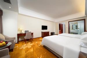 TV a/nebo společenská místnost v ubytování Xinghui Hotel