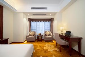 Postel nebo postele na pokoji v ubytování Xinghui Hotel