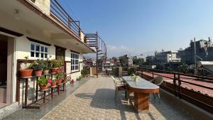 a balcony with a table and chairs on a building at Tala Vista Stay in Pokhara
