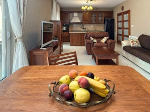 a bowl of fruit on a table in a living room at Blue Seagull in Utjeha +24 photos