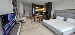 a bedroom with a bed and a television and a table at SEA BREEZE Baku-FH in Baku
