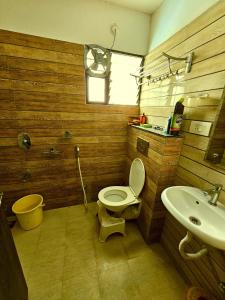 a bathroom with a toilet and a sink at Beautiful Appartment in Indore