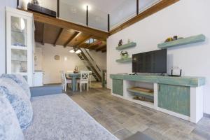 a living room with a television and a dining room at Casa Mica naturaleza y relax in Vega de San Mateo