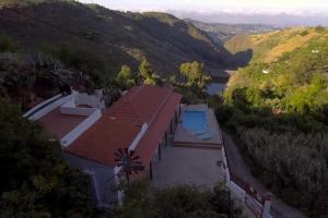 an aerial view of a house with a swimming pool at Casa Mica naturaleza y relax in Vega de San Mateo
