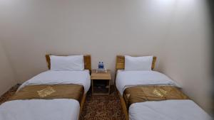 Letto o letti in una camera di Adventure Sarai Hotel Skardu