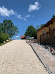 a driveway leading to a house with a barn at Mazurski Reset in Wilnowo
