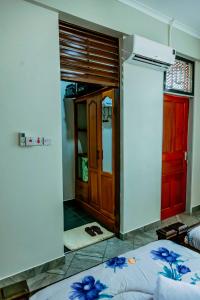 a room with a bedroom with a door and a bed at Bellevie Homestay in Uru